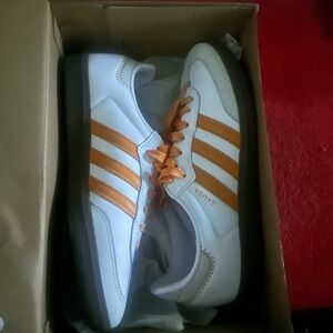 Orange and white adidas sambas